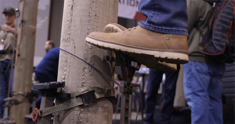 Someone standing on the HyperLite climbing sticks to demonstrate the steps.